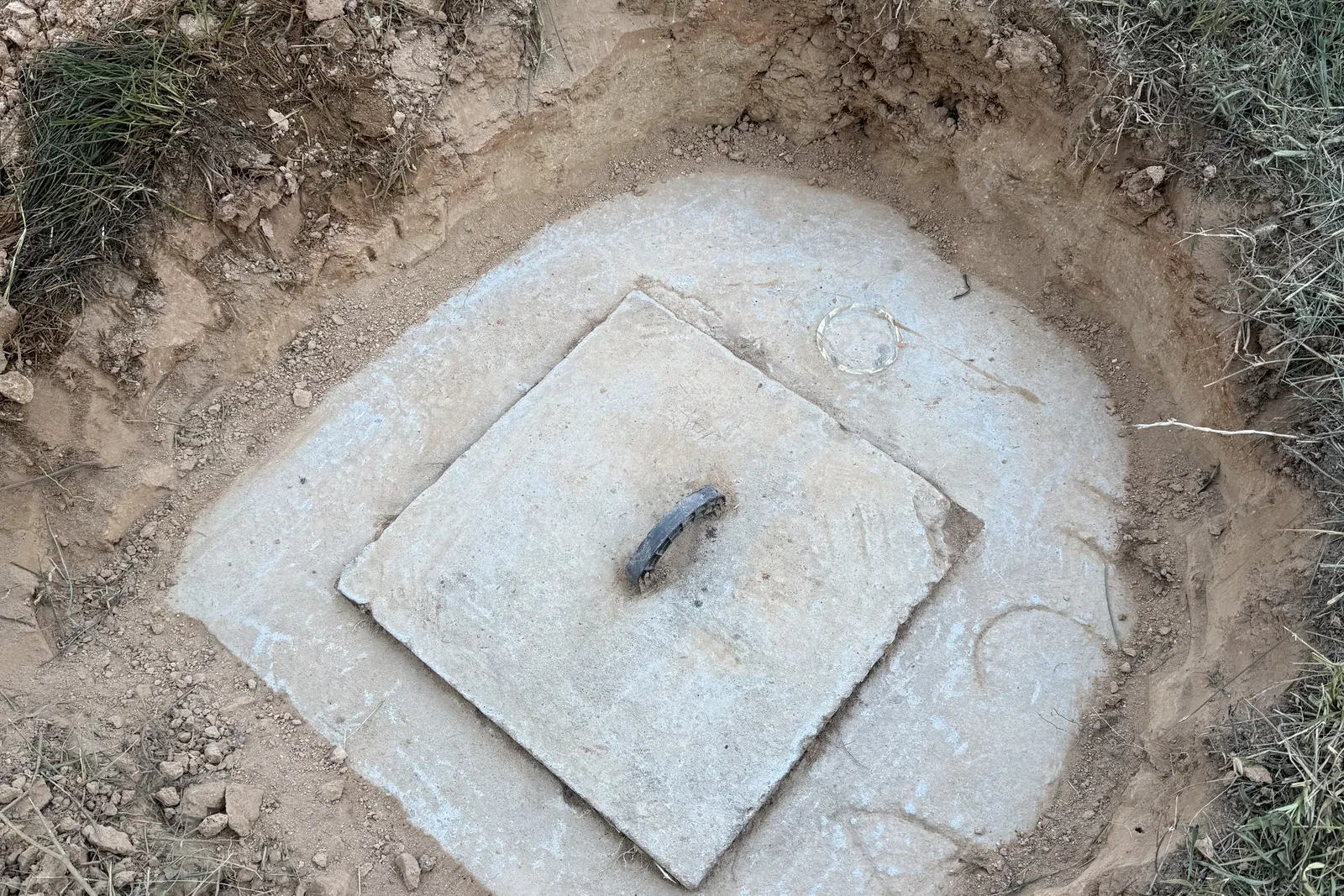 Original buried concrete septic tank lid uncovered before a riser was added