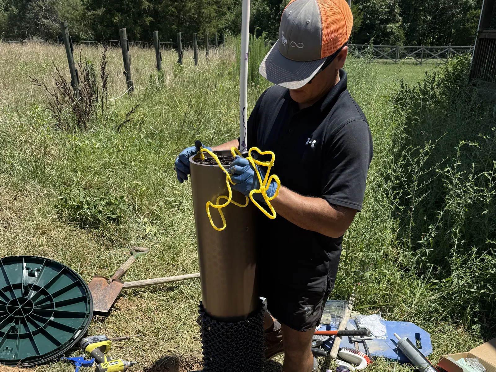 Everclear crew setting a riser on a septic tank during a restoration install