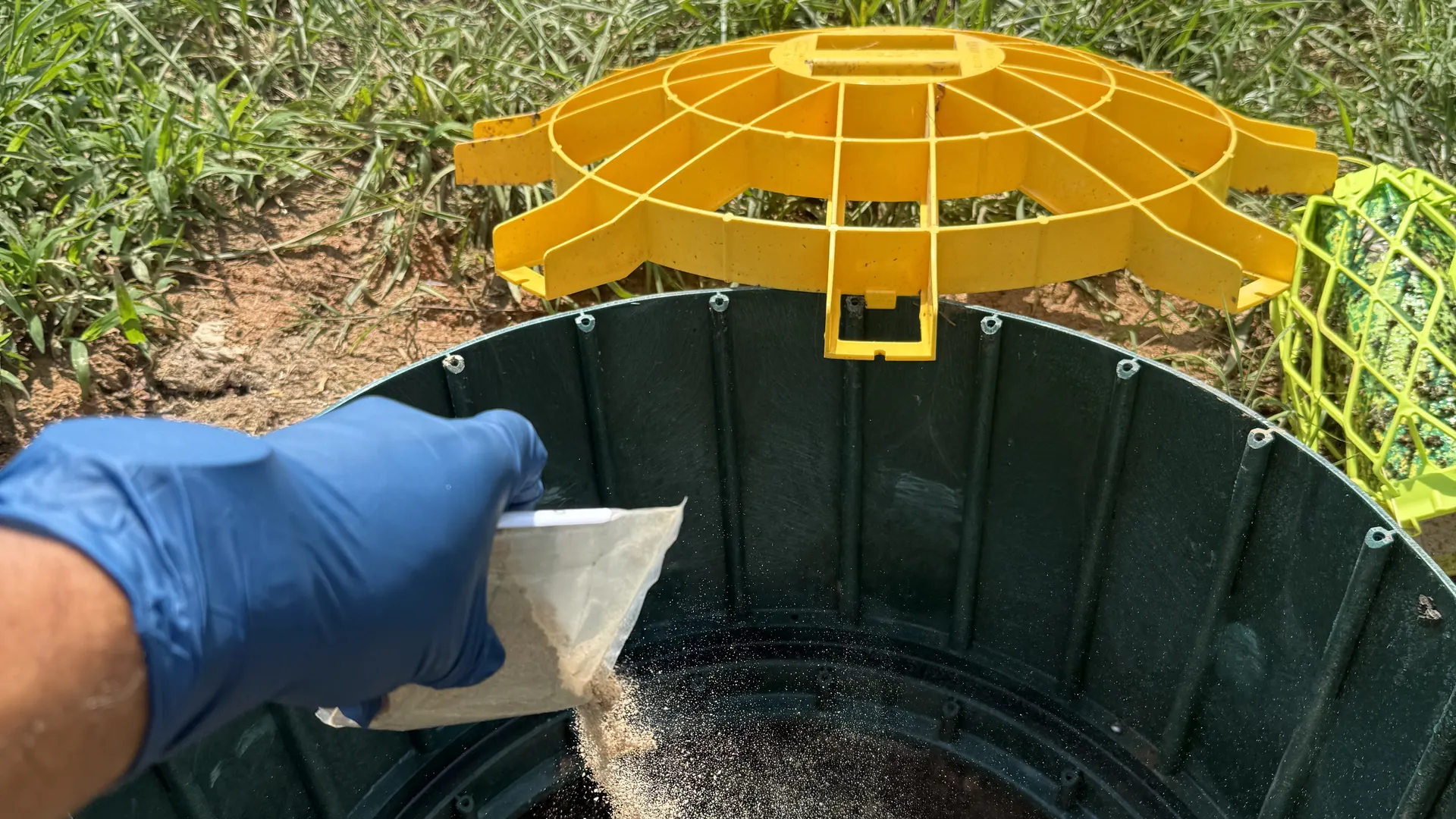 Septic tank risers installed at ground level in a North Carolina lawn after a drain field restoration