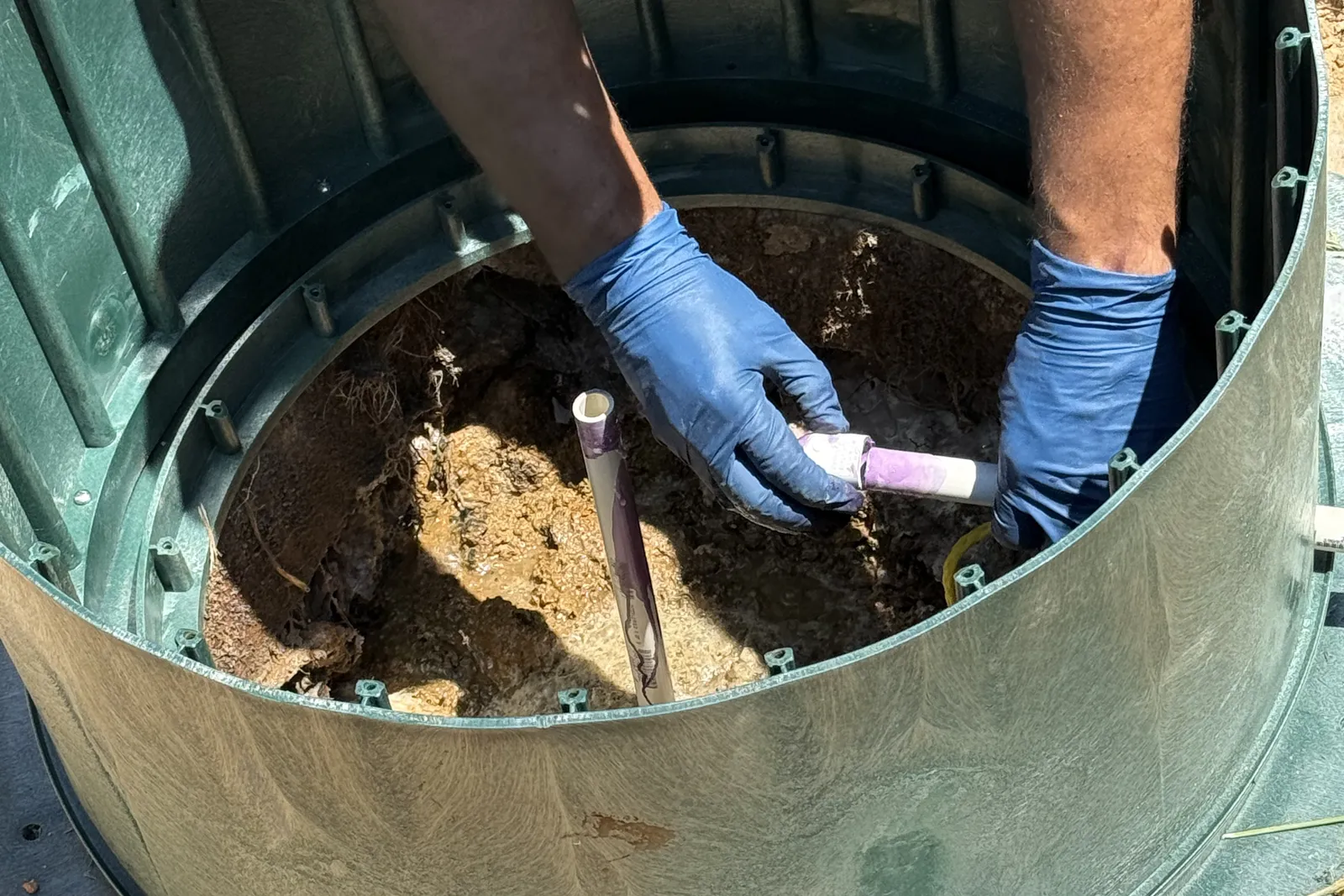 Fitting the air line pipe inside a septic tank riser