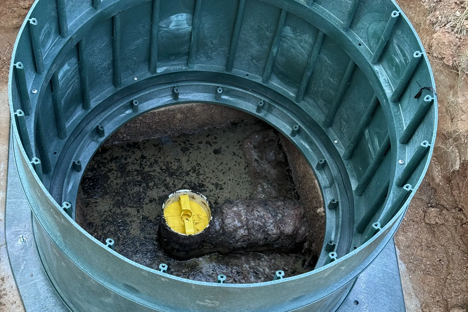 Looking down a septic riser at the outlet with the effluent filter cap in place