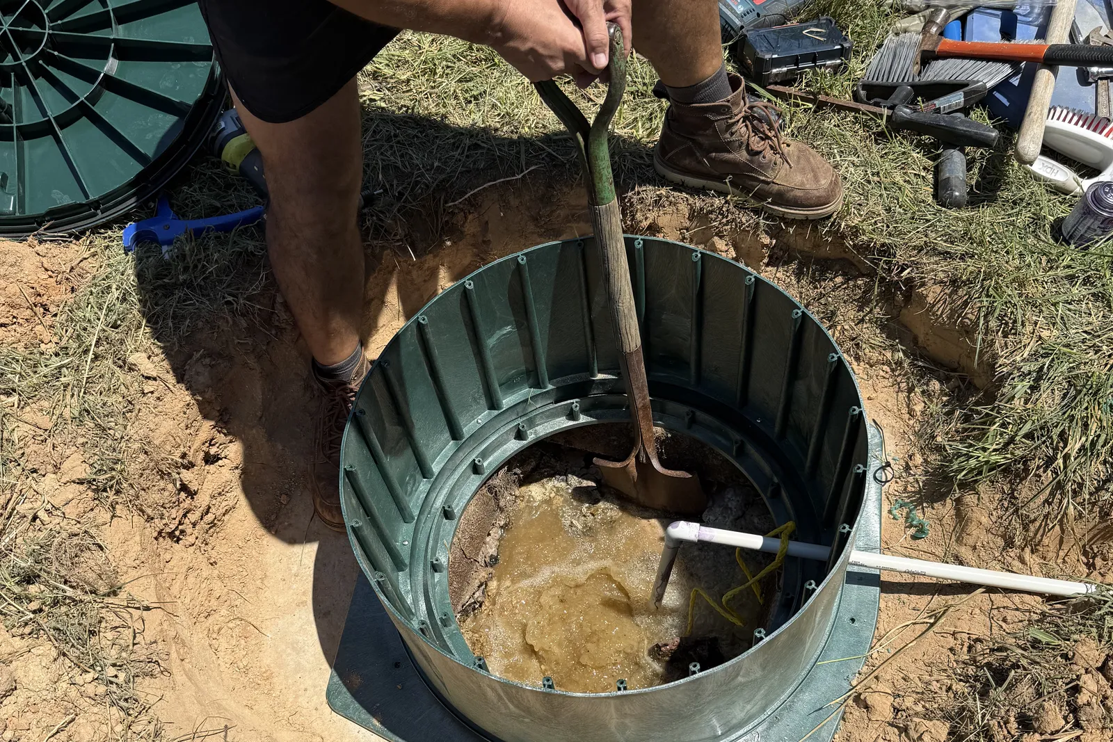 Septic system repair in Statesville, NC: breaking up the crust inside a failing tank