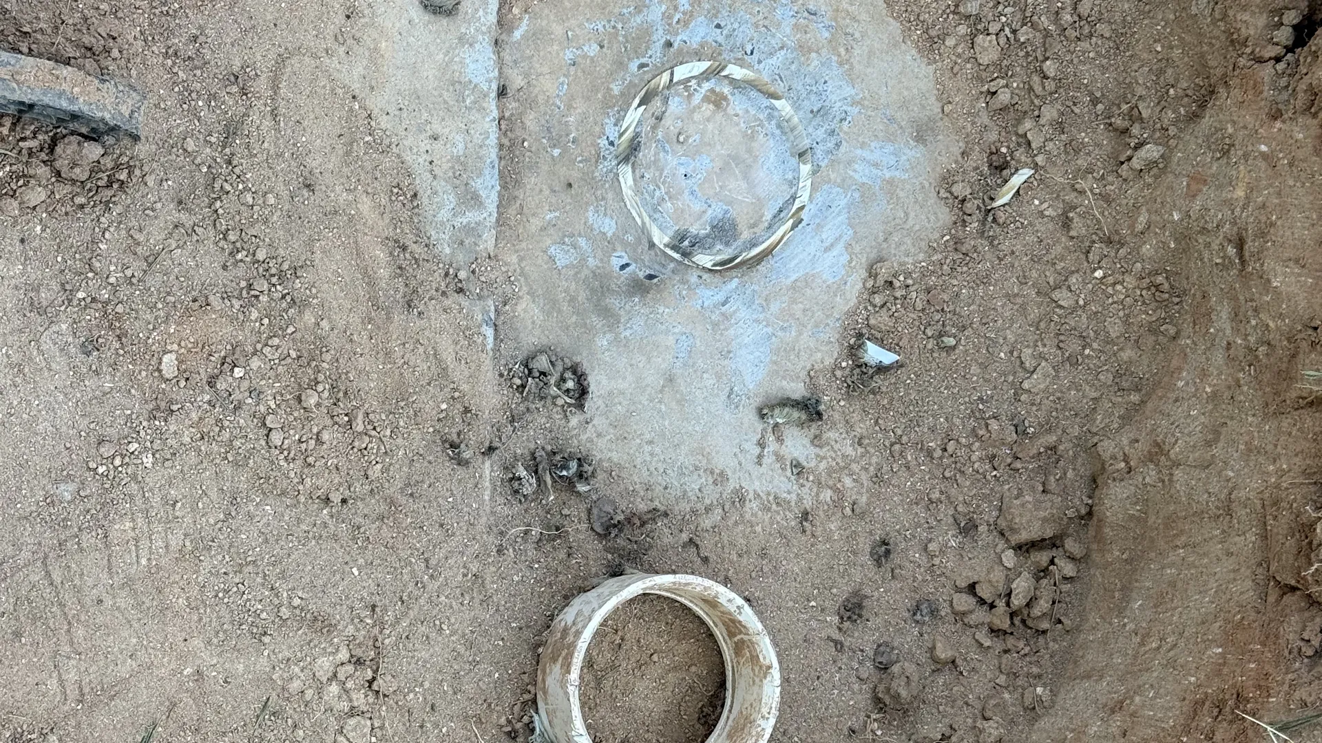 Access port ring scored into the top of a concrete septic tank