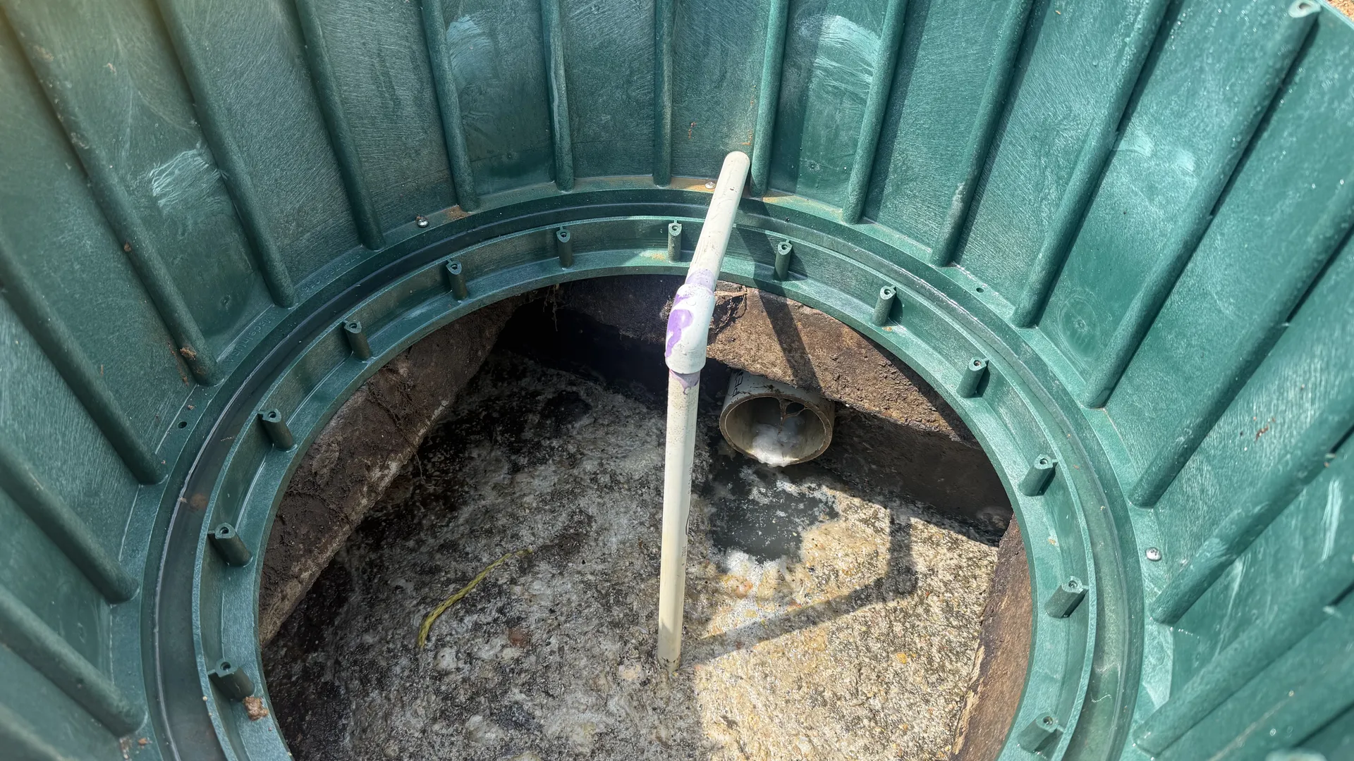 Air line drop pipe entering a septic tank