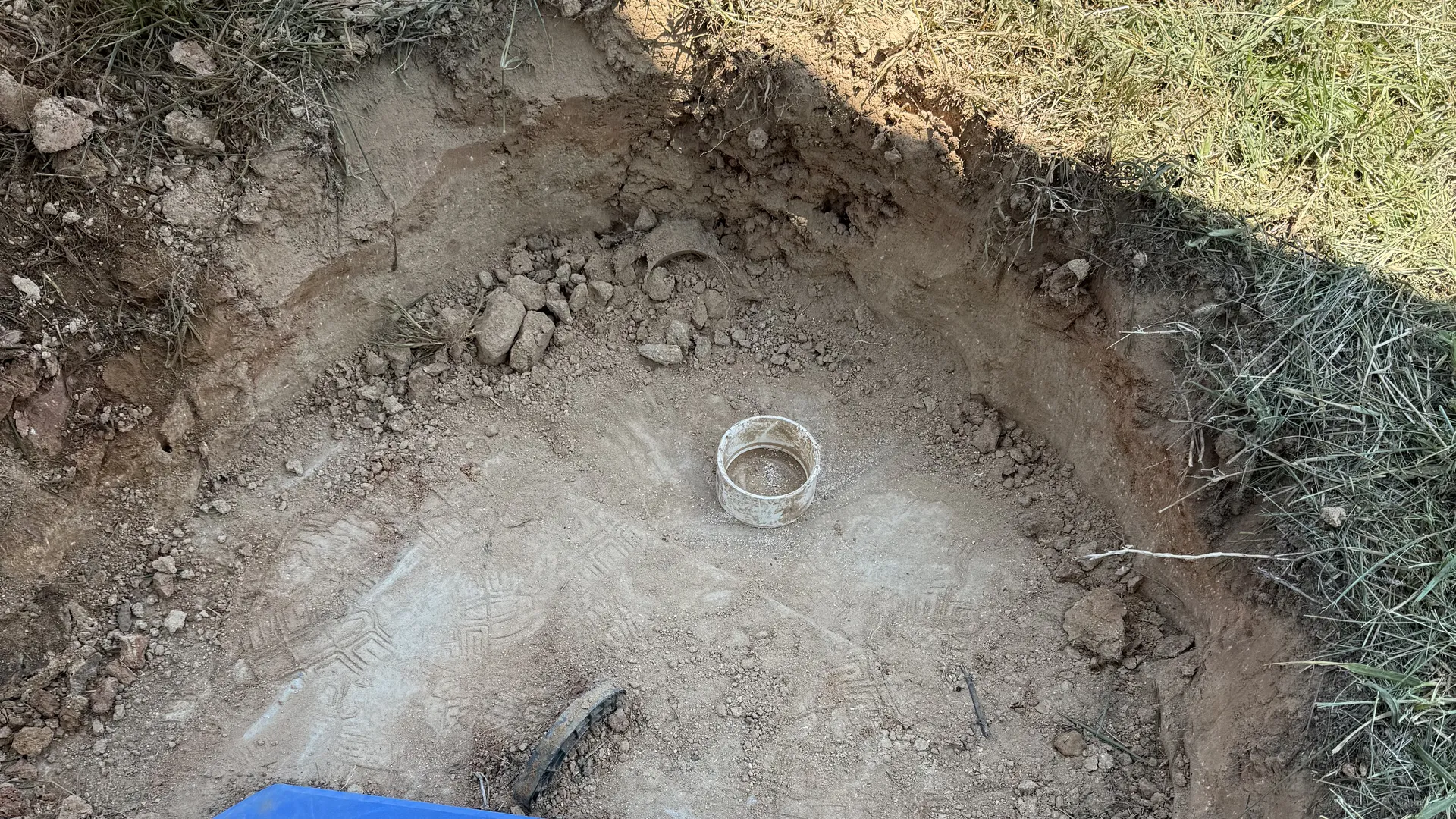 Concrete septic tank top uncovered through a small pit
